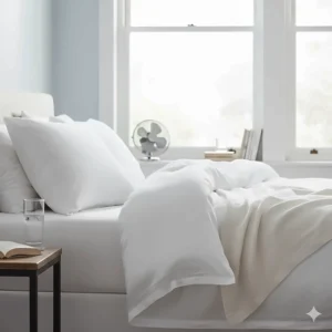 Light white linen sheets layered for a cool and breathable night’s sleep during a British summer.