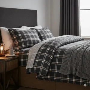 Warm and cosy brushed cotton super king duvet covers in a dark charcoal check pattern, layered with a grey knitted throw.