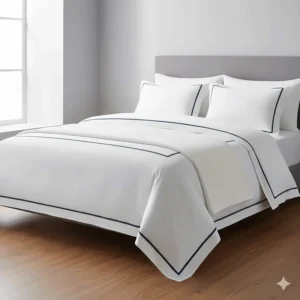 A minimalist hotel-style super king duvet cover in white with navy blue embroidered borders and matching oxford pillowcases.