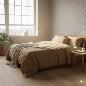 Soft morning light hitting a rumpled linen bedspread in a modern British loft-style bedroom.