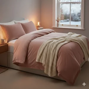 Soft blush pink crushed velvet bedding set styled with a chunky knit throw for a cosy winter feel.