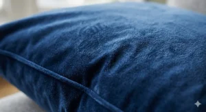 Close-up detail of soft navy blue velvet fabric showing the high-quality sheen and rich pile.
