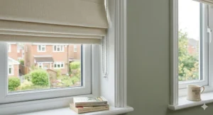 Cream blackout Roman blinds installed inside a window recess for a neat, flush finish.