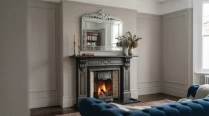 A vintage-inspired, etched Venetian glass mirror acting as a focal point above a classic fireplace.