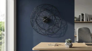 A luxurious brushed brass circular wall clock reflecting light in a stylish dining room setup under £80.