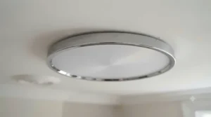 Close-up of a polished chrome and frosted glass flush ceiling light under £40 showcasing budget-friendly quality.