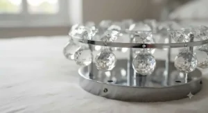 Close-up view of faceted glass crystals and polished chrome hardware on a luxury crystal flush ceiling light fitting