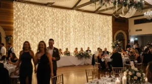 Romantic curtain fairy lights used as stunning backdrop lighting for a British wedding reception venue